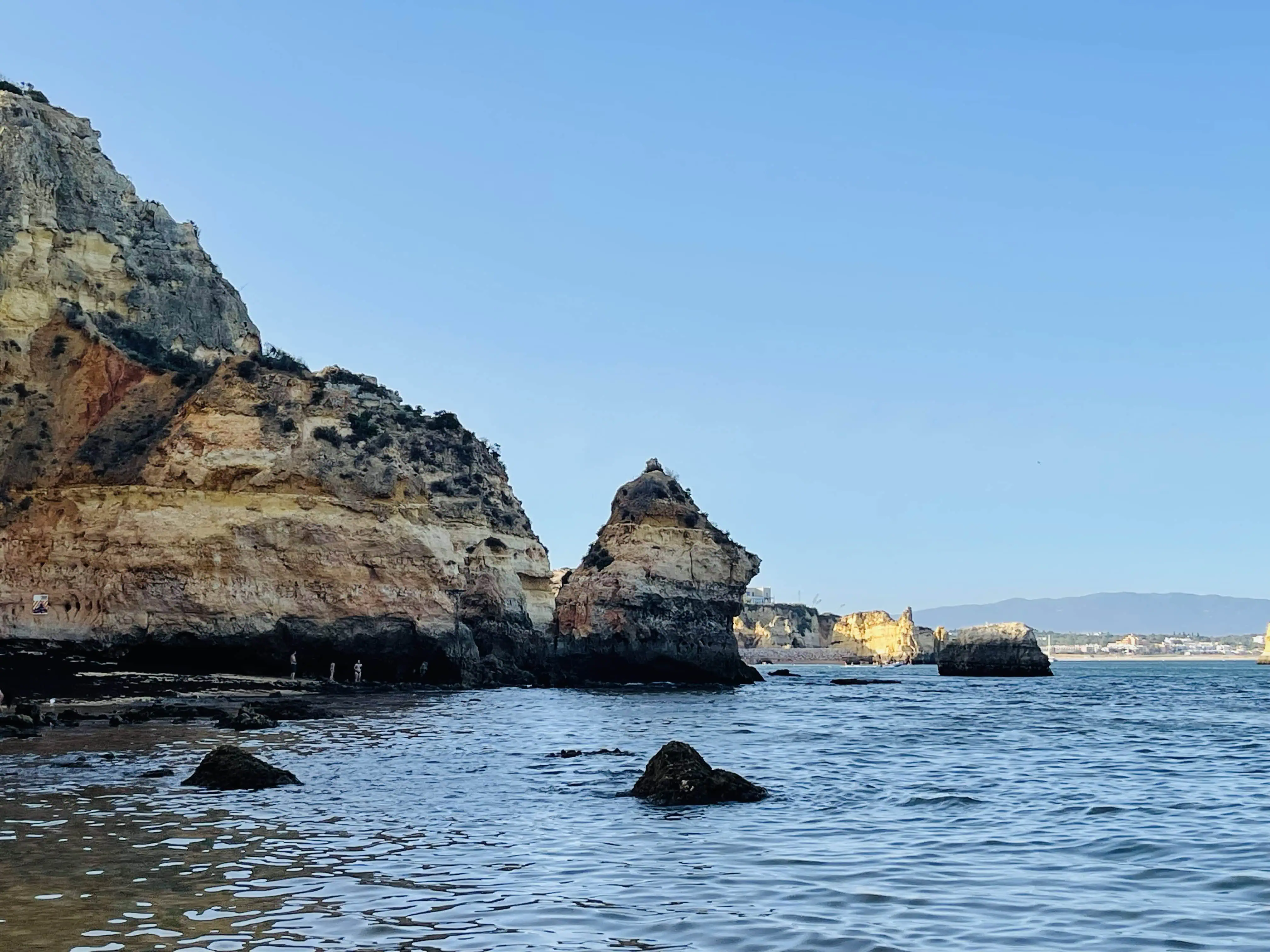 Rocky coastline of Praia do Camilo beach between the cliffs near the city of Lagos, Algarve.