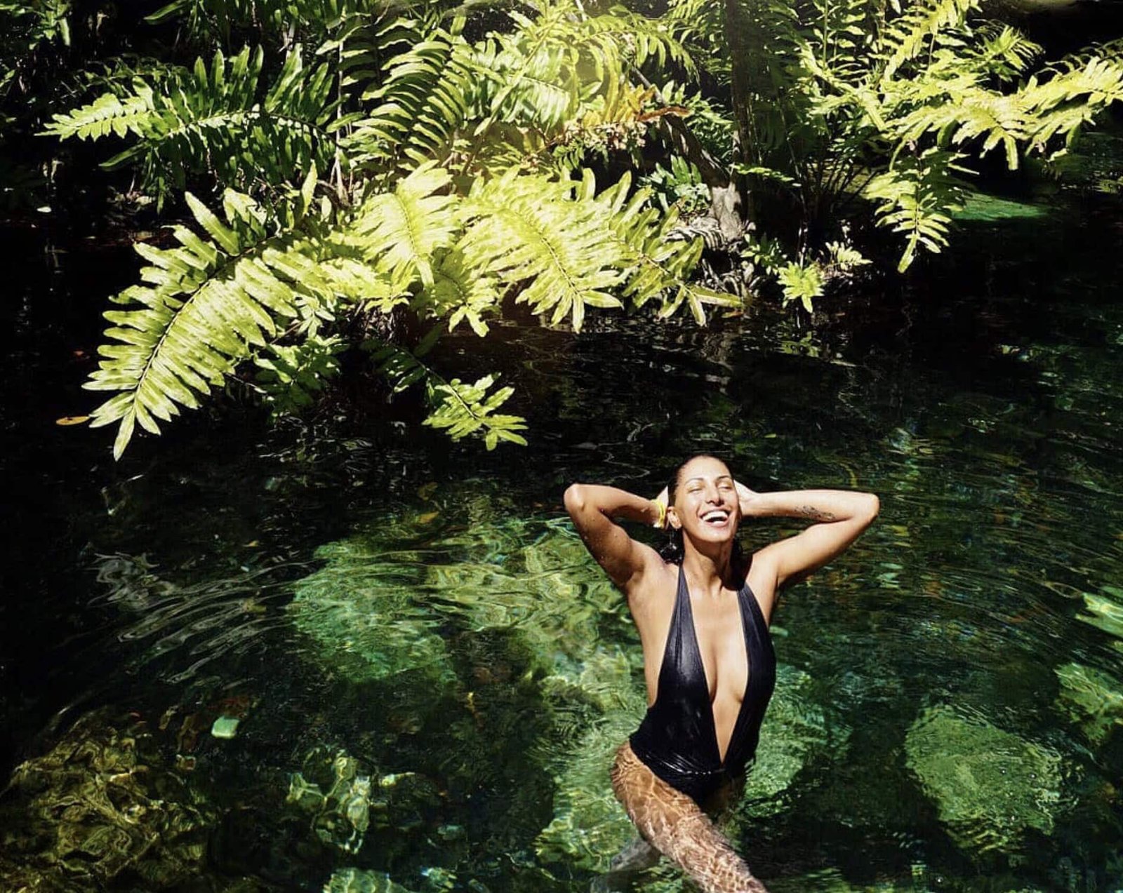 Cenote Cristalino: Full Guide (is it worth it in 2026?) 1 Woman laughing and holding her hair at cenote cristalino