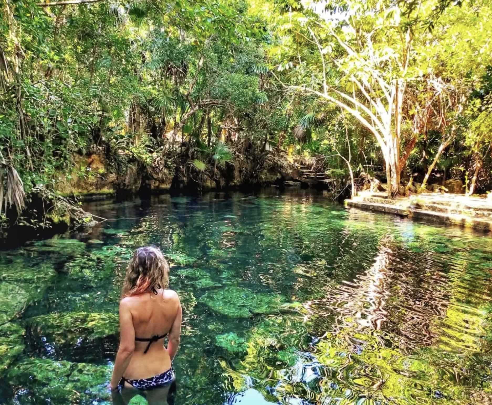 Woman bathing at cenote cristalino
