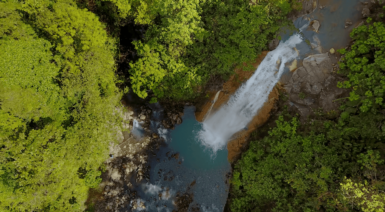 Bajos del Toro: A Full Guide to Costa Rica's Hidden Gem | 2026 3 Aerial view of a stunning waterfall in Bajos del Toro, Costa Rica, surrounded by lush green rainforest as it plunges into a turquoise pool.