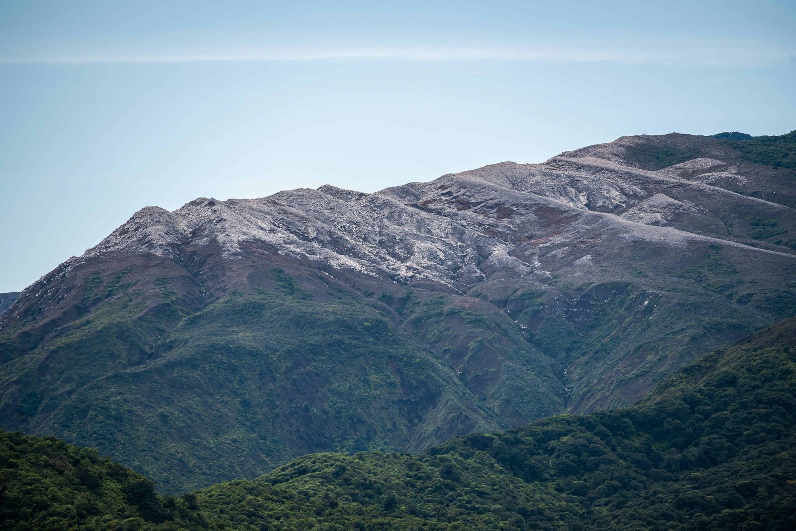 Poas Volcano: Worth a Visit in 2026? 10 Rocky Splendor - The hillside of the Poás volcano is rocky and whiteish, showcasing the raw and natural beauty of this Costa Rican landmark.