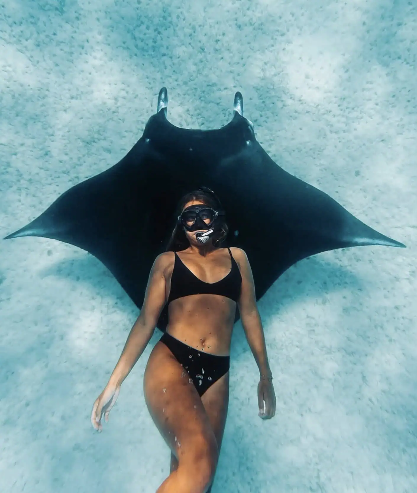 Snorkeling in the lagoon with a manta ray. One of the best things to do in Maupiti!