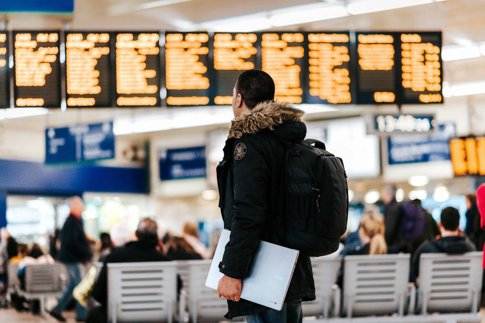 What Should You Do If Your Flight Is Cancelled? 3 flight cancellations, Traveler checking flight status on mobile app at airport