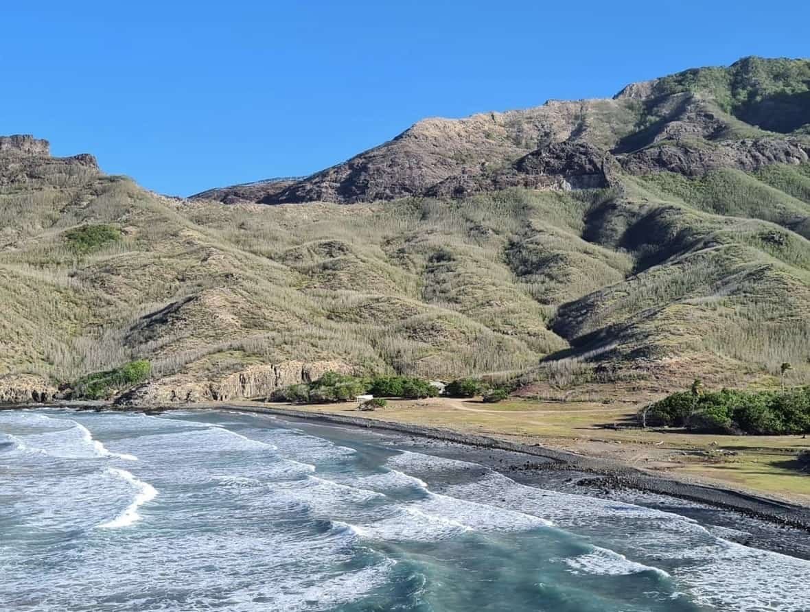 Ua Pou Marquesas Islands: A Full Guide For First-Timers 3 A beach with waves crashing on the shore in Ua Pou