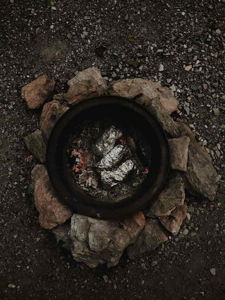 Hole in the ground. Normally covered with leaves and rocks so the heat stays within.