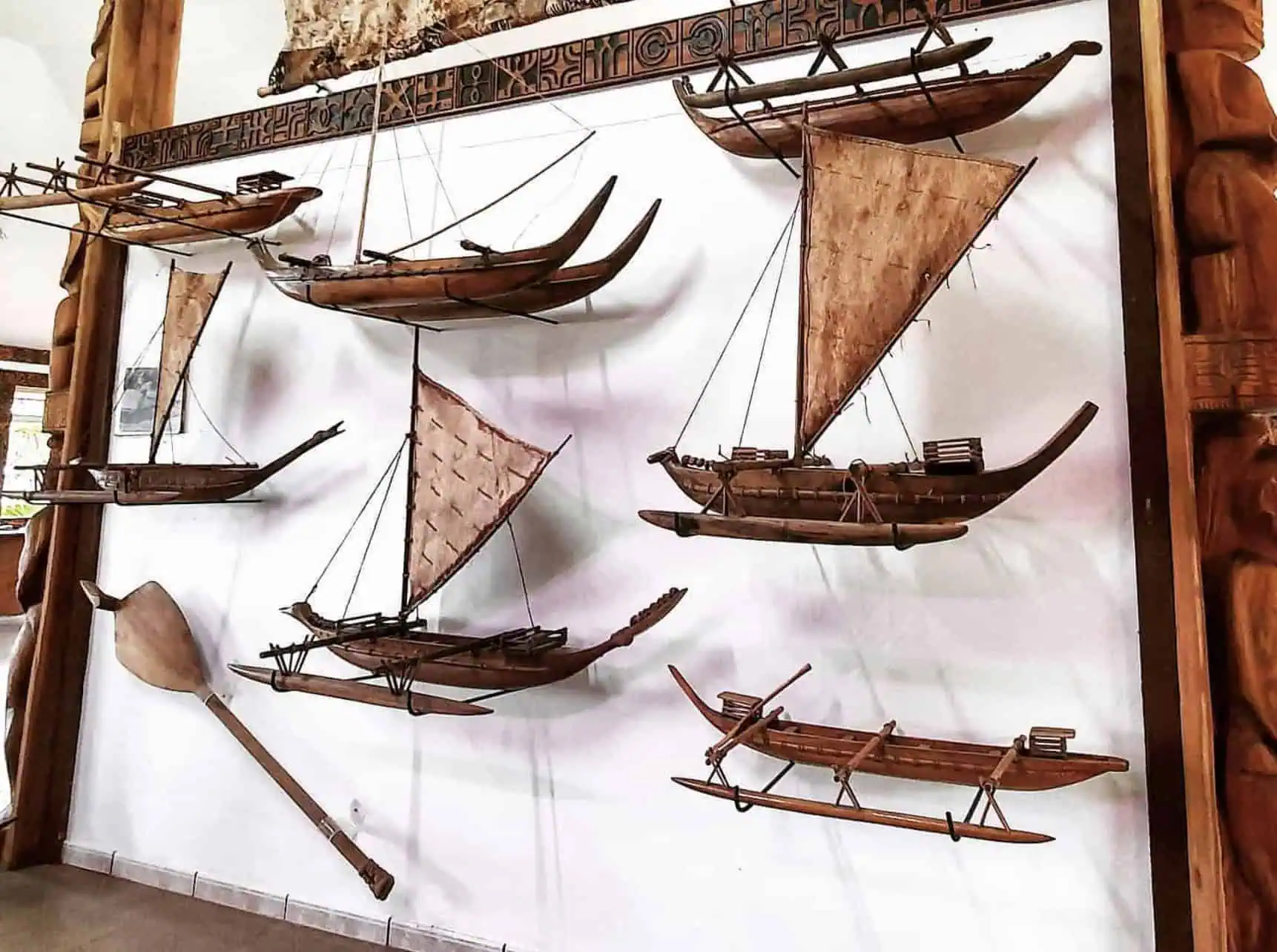 A group of boats on a wall in a Ua Huka Museum