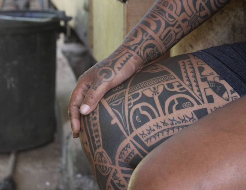 Why Visit Hiva Oa Island (TOP Things to do + Itinerary)! 8 a person with tattoos on their leg