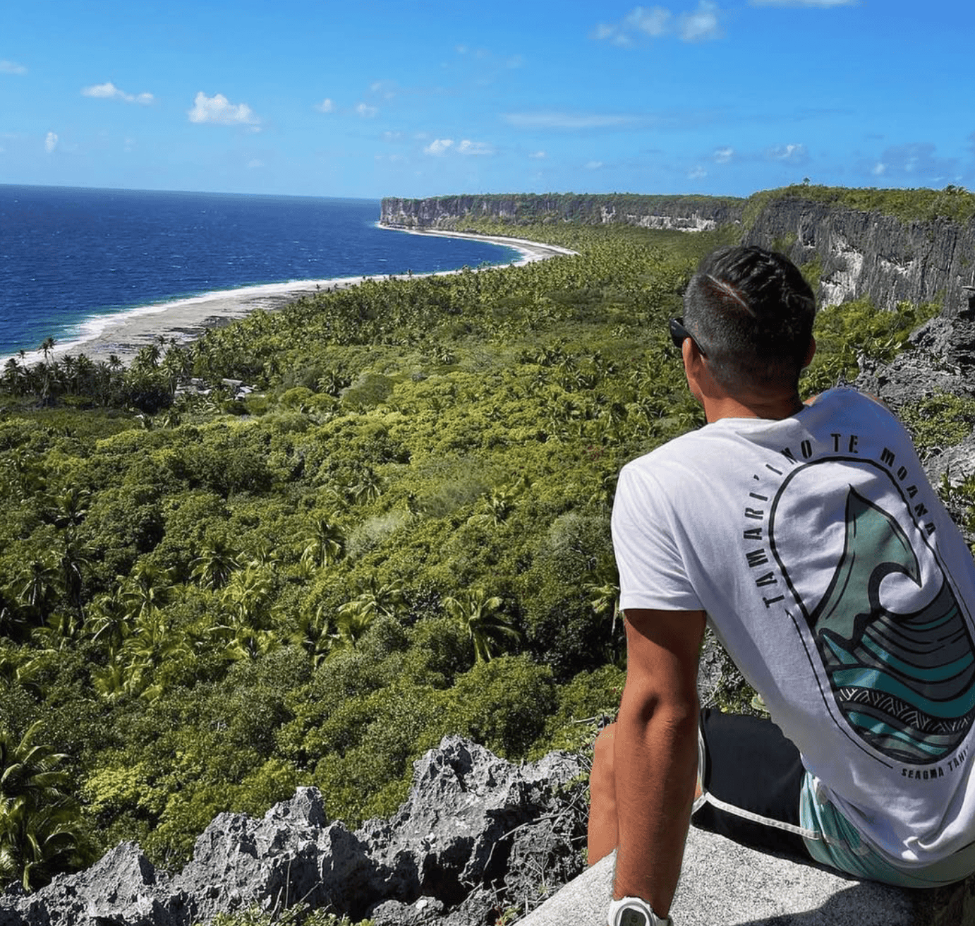 Makatea Island: The Complete Travel Guide (With Map)! 9 a man sitting on a cliff overlooking a body of water