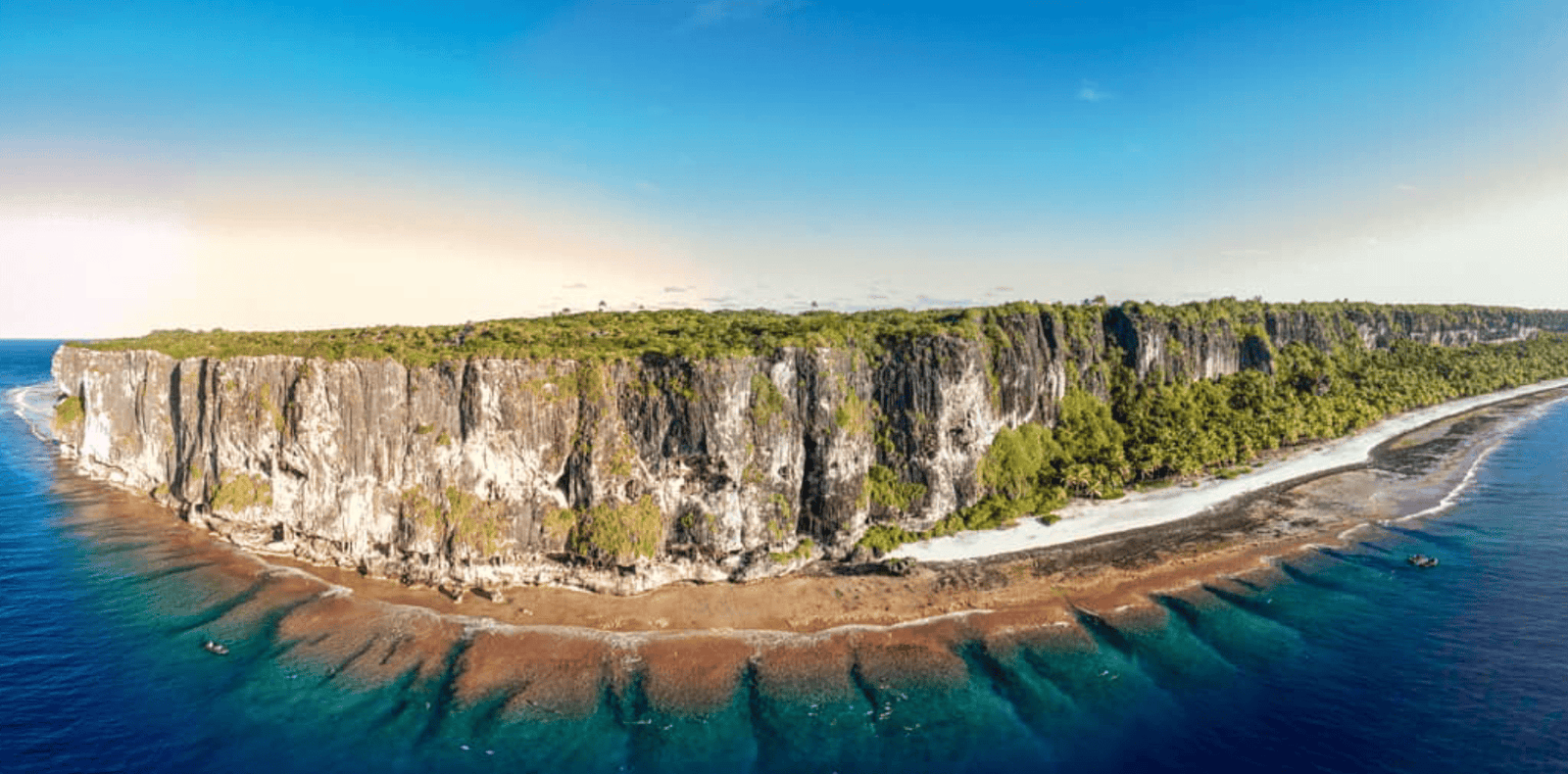 Makatea Island: The Complete Travel Guide (With Map)! 4 a cliff with trees on it and a beach