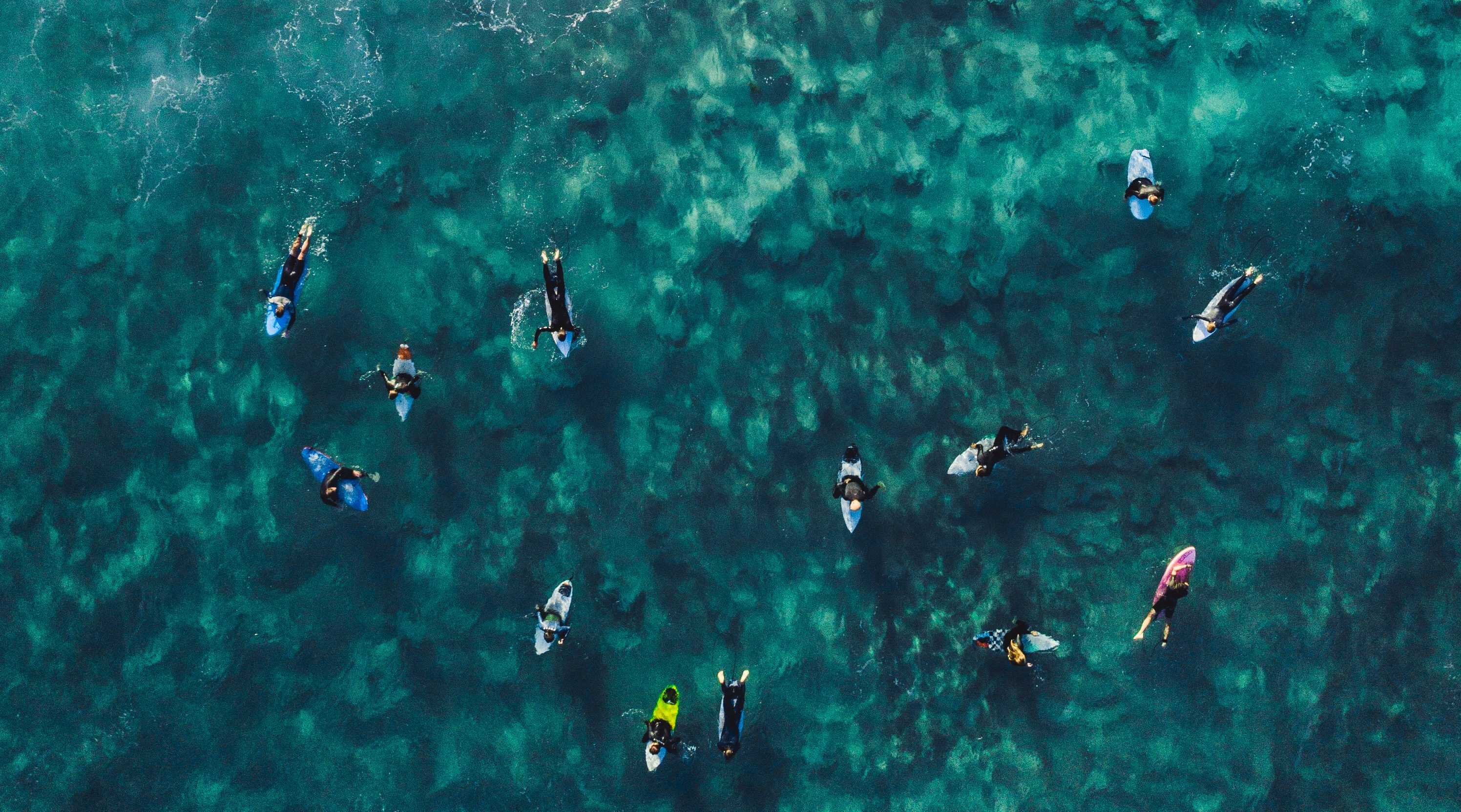 Marquesas Islands Surfing: What Are The Best Spots? 5 Group of surfers on a surfboard in the water