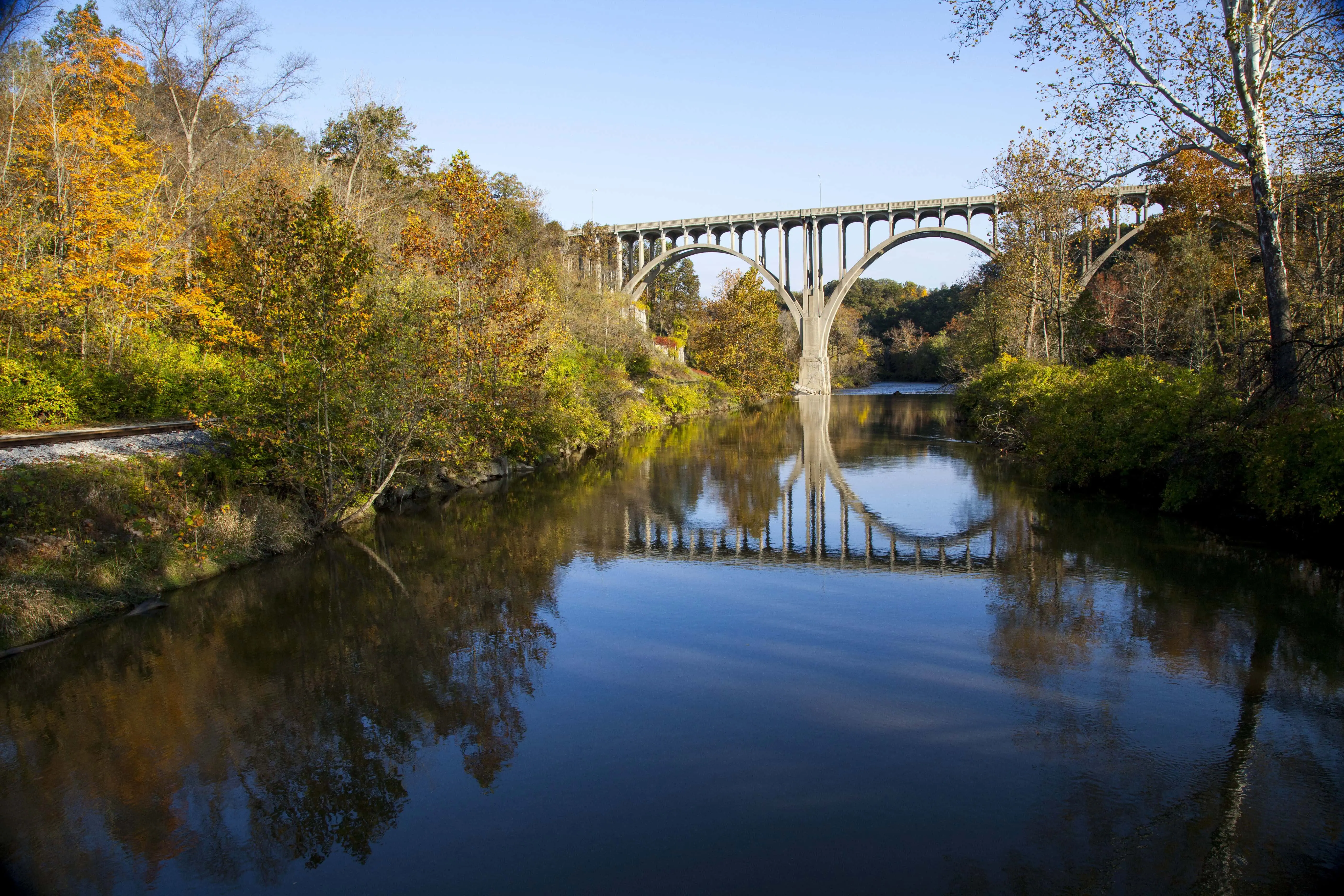 A beautiful shot of a bridge reflecting in the Cuyahoga River in Ohio on a beautiful autumn day