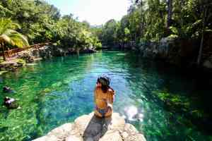 Woman relaxing at Cenote tortuga in Tulum