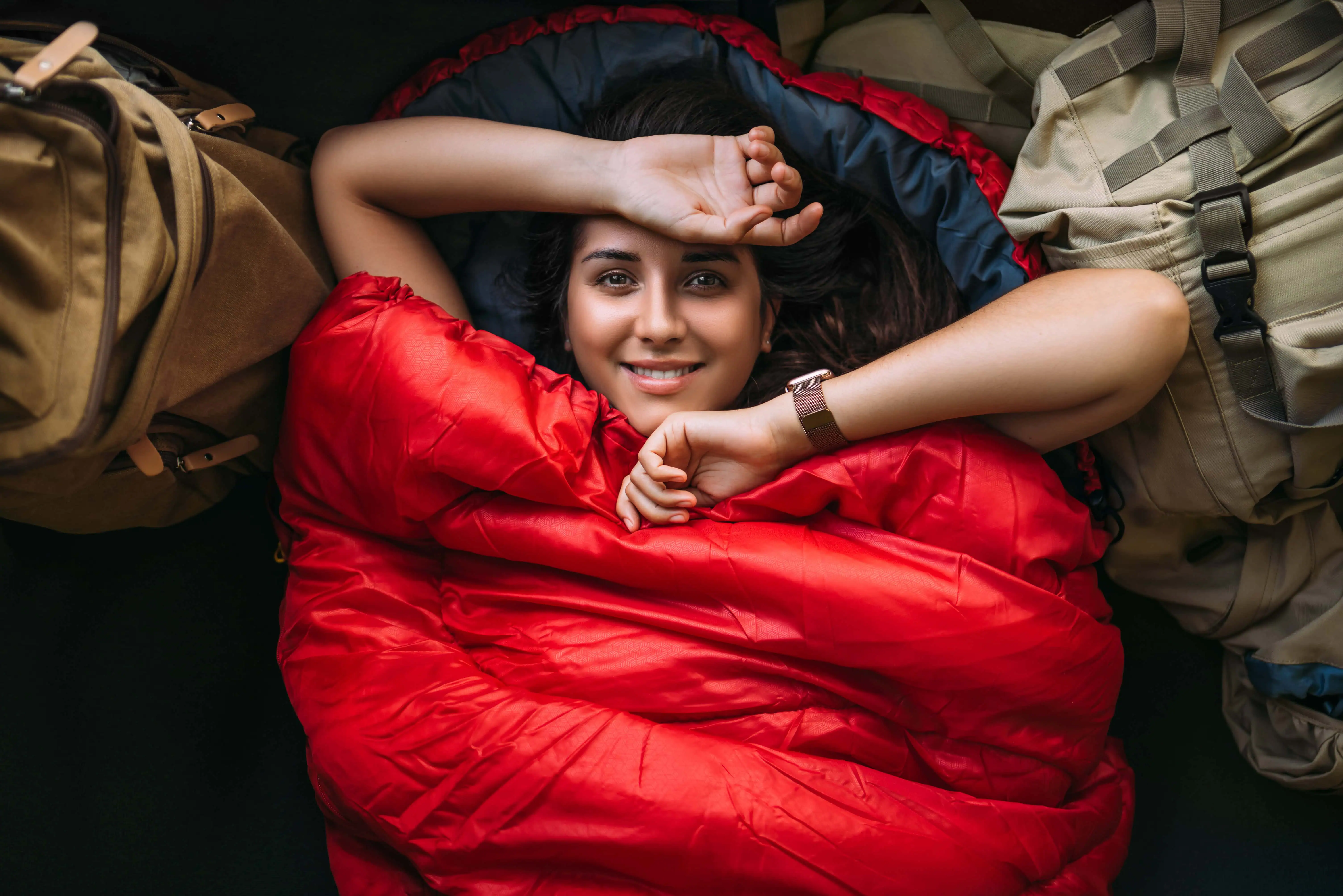 A tourist is resting in a sleeping bag.