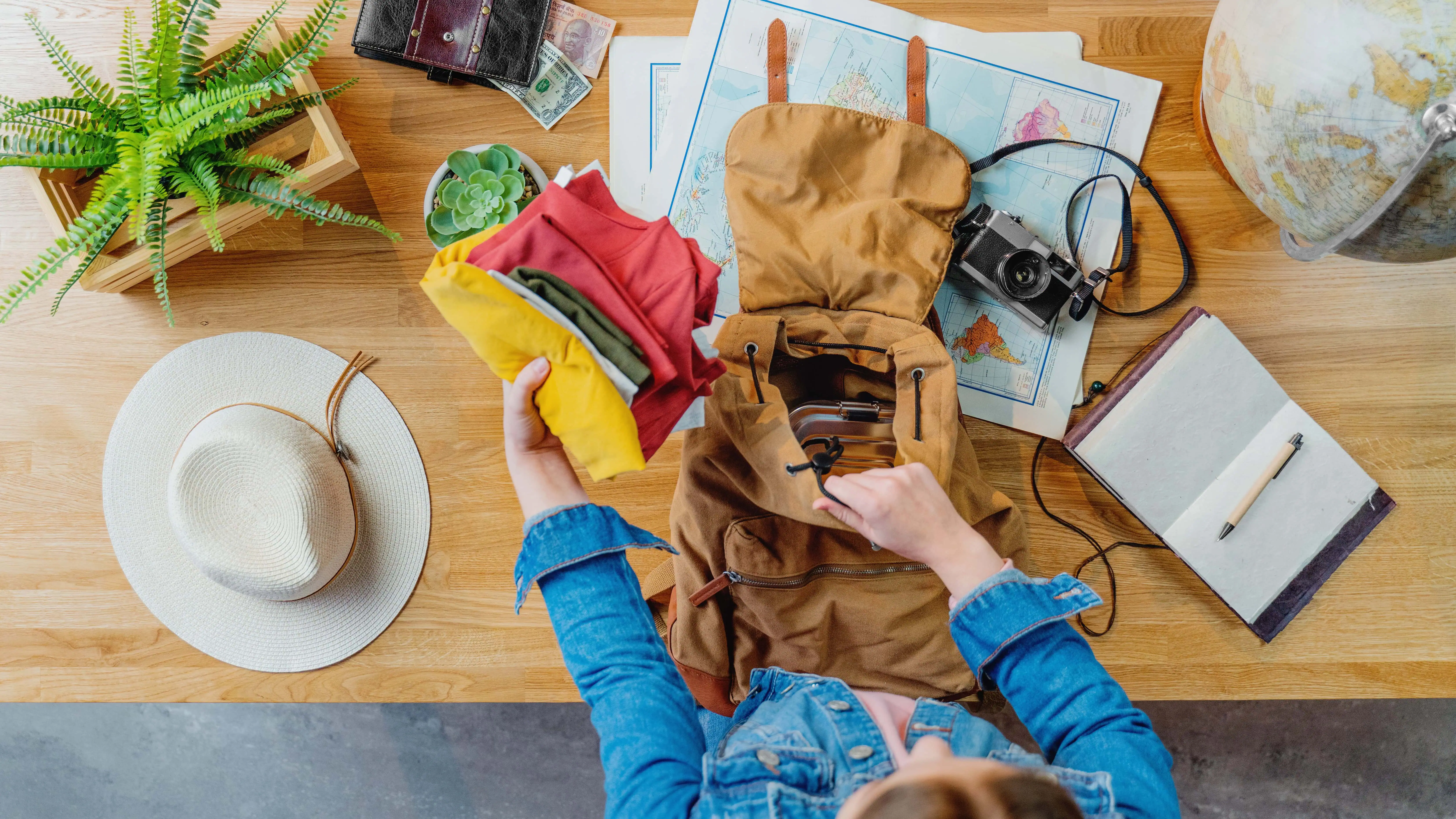 Woman packing her backpack for camping.