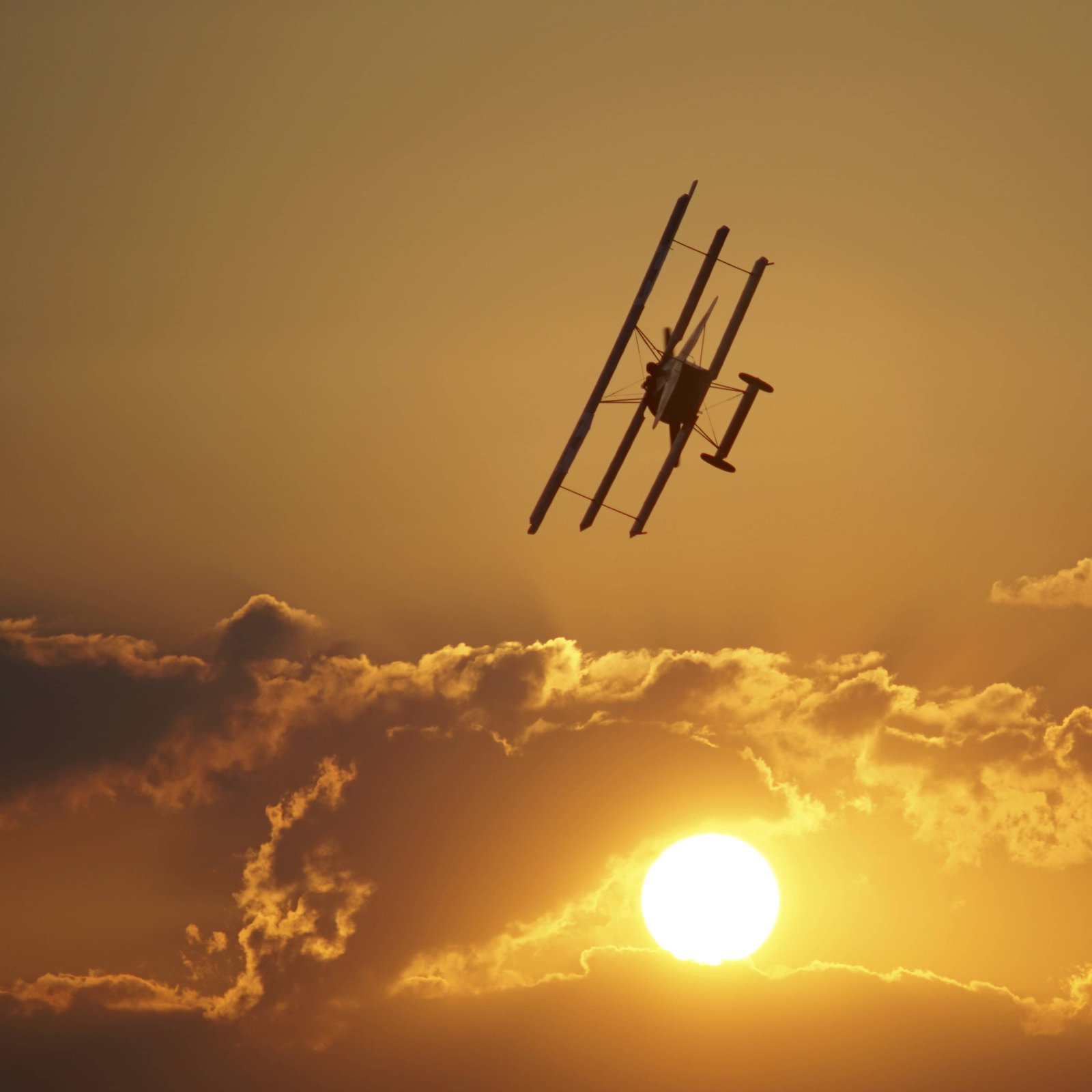 What Are The Top Things To Do in Dayton, Ohio? 6 One of the Wright planes in the sky during the orange sunset in Dayton, Ohio