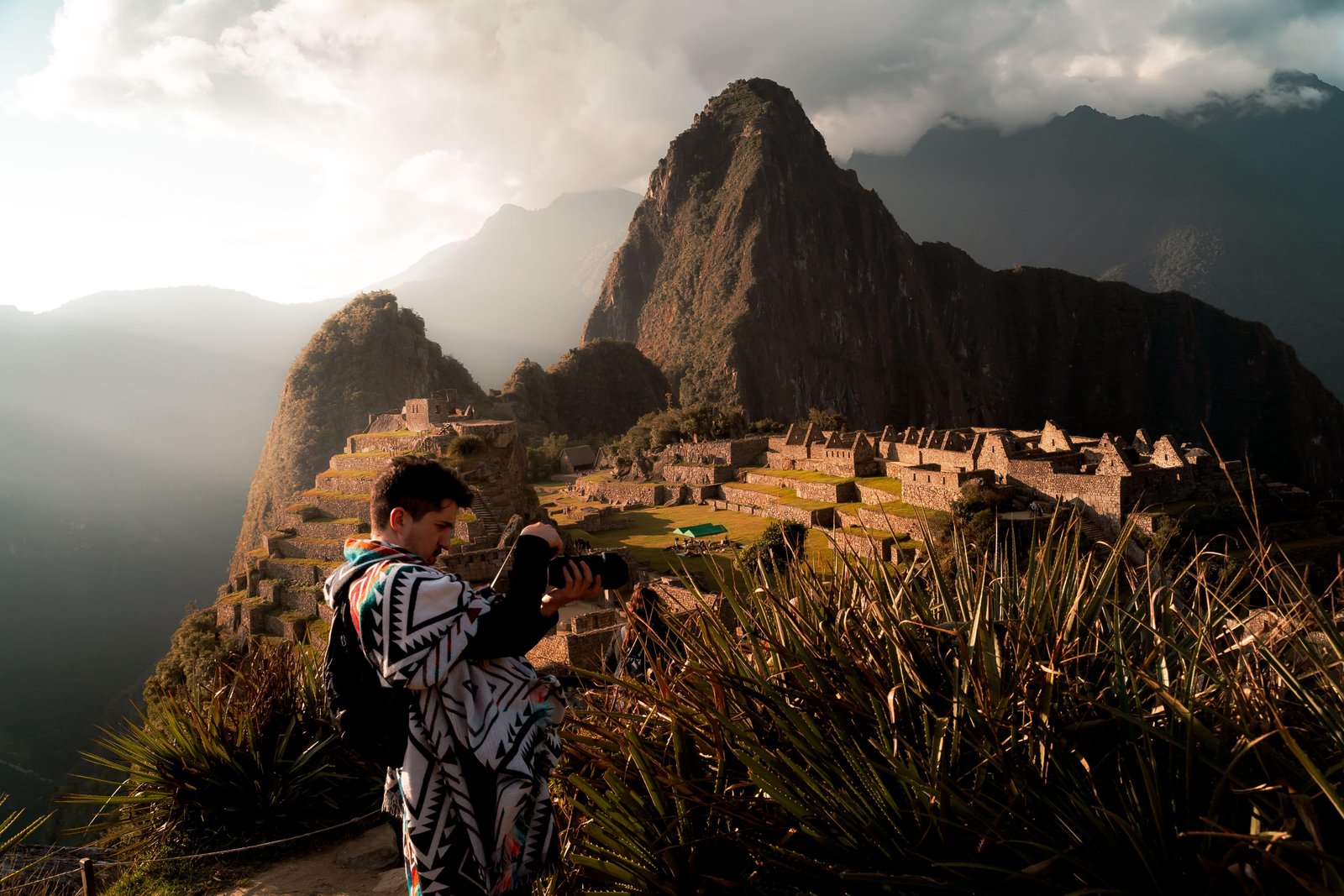 4-Day Classic Inca Trail Hike Guide! 2 A photographer capturing the breathtaking view of Machu Picchu in Peru during sunset with a mountain backdrop.